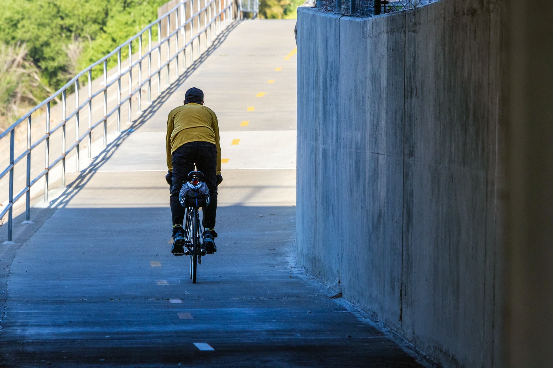 A rider on a value electric bike on a sunlit street