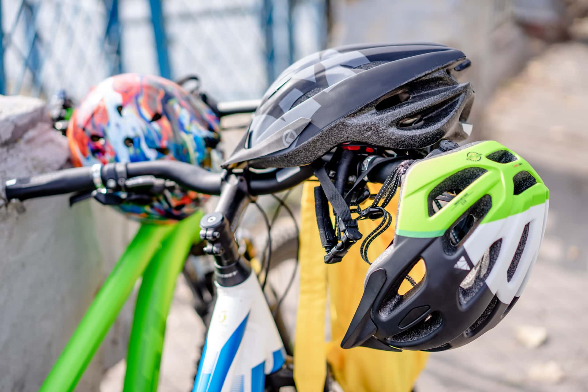 A cycling helmet resting on bicycle handlebars