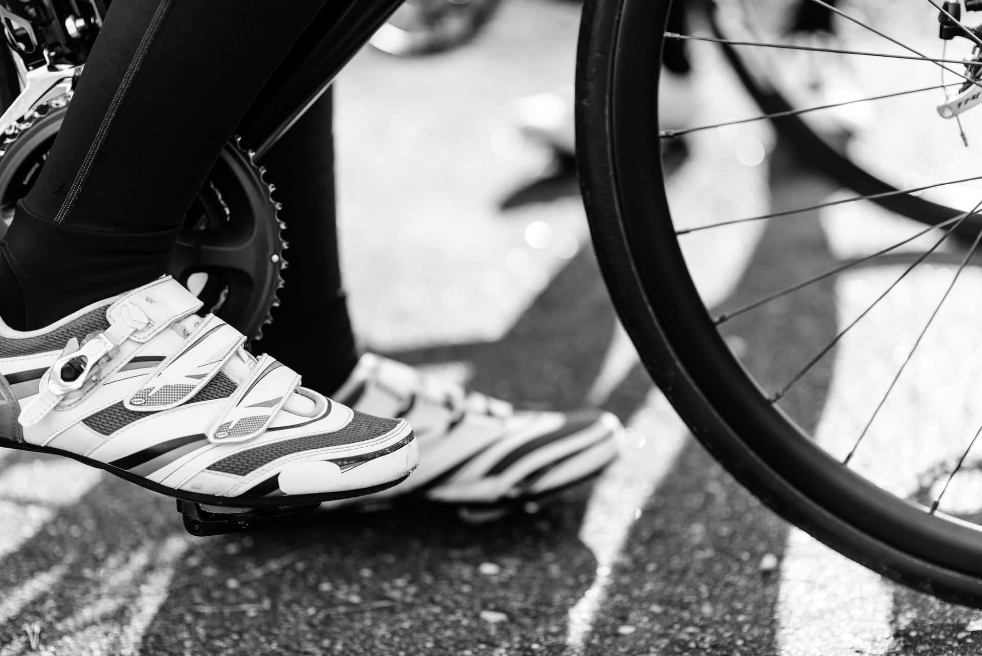 A pair of cycling shoes clipped into pedals